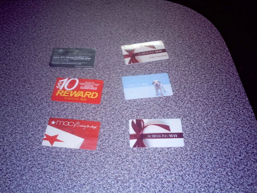 Several store gift cards laid out on a table