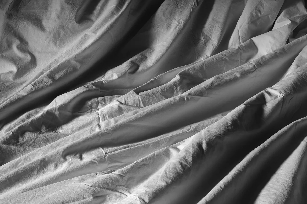 Threshold Washed Cotton Sateen Duvet Cover & Sham Set, King (New with tags): stock photo (Stock photo, not the actual product: a crumpled white cotton duvet cover in window light), not the actual product