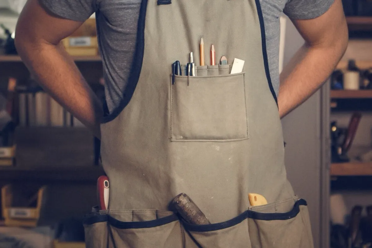 Klein Tools 55832MB MODbox 8-Pocket Tool Pouch: stock photo (A canvas work apron with tools and pencils in its pockets), not the actual product